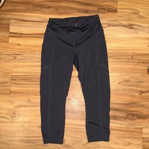 Capris leggings with pockets. Gray in color. Medium in size.